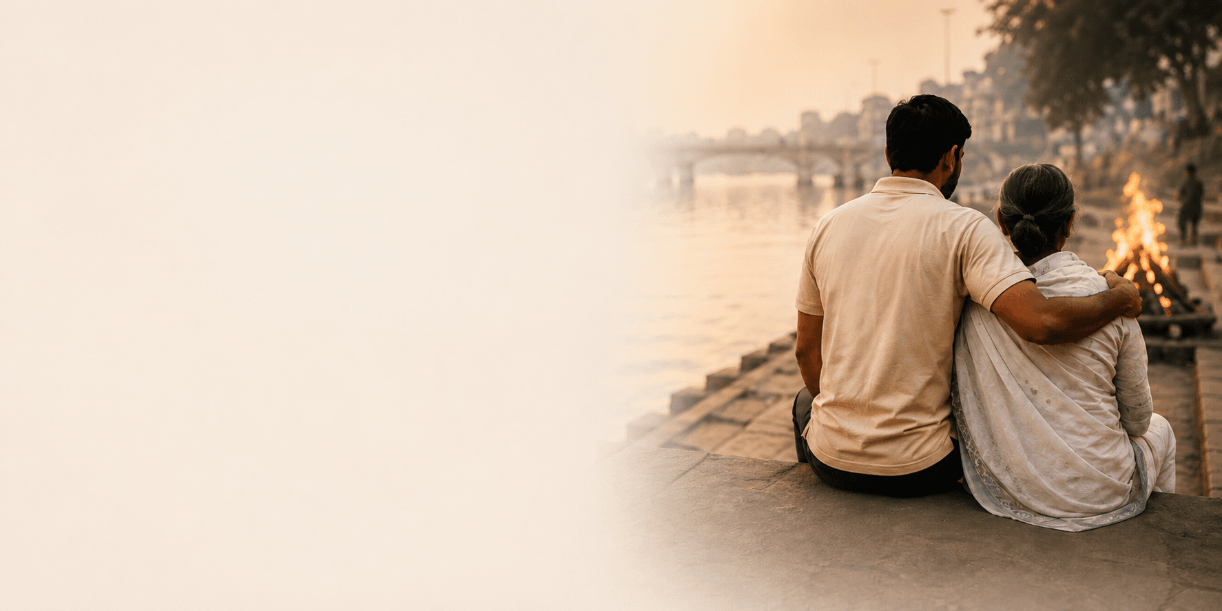 A volunteer sitting beside an elderly woman, watching the sunset over a river ghat