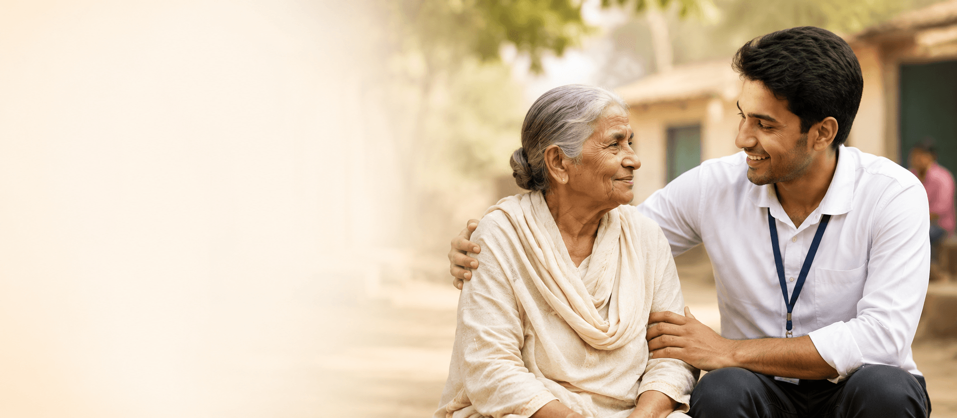 Moksha Sewa volunteer sitting with and comforting an elderly woman